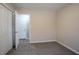 Bedroom showcasing neutral walls, a large closet, soft carpeting, and a glimpse into an adjacent space at 3482 Scenic Dr, Atlanta, GA 30344