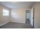 Bedroom boasting neutral walls, soft carpeting, a window, and an open doorway to a connected space at 3482 Scenic Dr, Atlanta, GA 30344