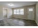 Living room featuring a neutral color palette, hardwood floors, a large window, and white trim throughout at 3482 Scenic Dr, Atlanta, GA 30344