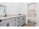 Bathroom with double sink vanity, granite countertop, and tiled shower at 485 N Oakland Cir, Mcdonough, GA 30253