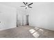 Light and airy bedroom featuring neutral carpet, white walls, ceiling fan and closet at 485 N Oakland Cir, Mcdonough, GA 30253