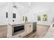 Granite topped kitchen island features seating and stainless appliances set in an open concept design at 485 N Oakland Cir, Mcdonough, GA 30253