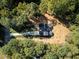 A bird's eye view of a cozy home nestled among the trees with long driveway at 485 N Oakland Circle, Mcdonough, GA 30253