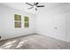 Bright bedroom with neutral carpet, ceiling fan, and large windows at 485 N Oakland Circle, Mcdonough, GA 30253