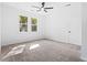 Bright bedroom featuring carpet, ceiling fan and large windows at 485 N Oakland Circle, Mcdonough, GA 30253