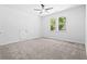 Bedroom with grey carpet, ceiling fan and access to attic storage at 485 N Oakland Circle, Mcdonough, GA 30253