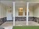 Front porch showcasing stone accents, white pillars, and a classic door with natural light at 485 N Oakland Circle, Mcdonough, GA 30253