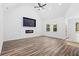 Light-filled living area with wood flooring, modern fireplace, built-in TV, and large windows at 485 N Oakland Circle, Mcdonough, GA 30253