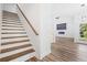 Staircase featuring wood treads and a hallway view with wood flooring at 485 N Oakland Circle, Mcdonough, GA 30253