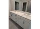 Double vanity bathroom with quartz countertop and gray tile flooring at 576 Rodeo Dr, Auburn, GA 30011