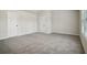 Spacious bedroom with neutral carpeting and two doors at 576 Rodeo Dr, Auburn, GA 30011