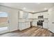 White shaker cabinets, stainless steel appliances, and vinyl flooring at 576 Rodeo Dr, Auburn, GA 30011