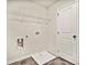 Bright laundry room with built-in shelving and drain at 576 Rodeo Dr, Auburn, GA 30011