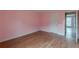 Empty bedroom with pink walls and wood flooring at 601 Rangeley Meadows Ct, Hampton, GA 30228