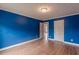 Blue bedroom with wood flooring at 601 Rangeley Meadows Ct, Hampton, GA 30228