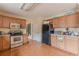 Kitchen features light brown cabinets and tile flooring at 601 Rangeley Meadows Ct, Hampton, GA 30228