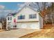 Two-story house with gray siding, red door, and a two-car garage at 82 Summer Creek Pl, Dallas, GA 30157