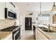 Modern kitchen with stainless steel appliances, granite countertops, and white cabinetry at 1440 Vinery Ave, Cumming, GA 30041