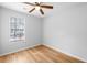 Bright bedroom with wood-look floors and ceiling fan at 6300 Creekford Dr, Lithonia, GA 30058