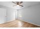 Bright bedroom with wood-look floors and ceiling fan at 6300 Creekford Dr, Lithonia, GA 30058