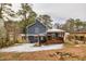 Gray house with wooden deck and snowy yard at 6300 Creekford Dr, Lithonia, GA 30058