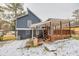 Gray house with wooden deck and snowy yard at 6300 Creekford Dr, Lithonia, GA 30058