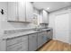 Updated kitchen boasts gray cabinets, granite countertops, and stainless steel appliances at 6300 Creekford Dr, Lithonia, GA 30058