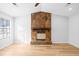 Living room with a large stone fireplace and light-colored flooring at 6300 Creekford Dr, Lithonia, GA 30058