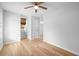 Bright living room with hardwood floors, ceiling fan, and fireplace at 6300 Creekford Dr, Lithonia, GA 30058