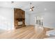 Living room with stone fireplace, light walls, and wood-look floors at 6300 Creekford Dr, Lithonia, GA 30058