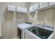 Well-equipped laundry room with washer, dryer, and ample shelving at 1265 Gallatin Way, Suwanee, GA 30024