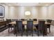Community dining room with a large wooden table and leather chairs at 1820 Peachtree Nw St # 1909, Atlanta, GA 30309