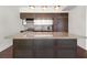 Kitchen island with granite countertop and dark wood cabinets at 1820 Peachtree Nw St # 1909, Atlanta, GA 30309