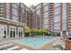 Resort-style swimming pool with plenty of lounge chairs at 1820 Peachtree Nw St # 1909, Atlanta, GA 30309