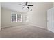 Bright bedroom with two windows, ceiling fan, and carpet flooring at 215 Brookwood Cv, Atlanta, GA 30349