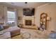 Living room with sectional sofa and brick fireplace at 340 New Alcovy Rd, Social Circle, GA 30025