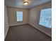 Bright bedroom with two windows and neutral wall colors at 4220 Sw Notting Hill Sw Dr, Atlanta, GA 30331