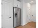 Stainless steel refrigerator in kitchen with white cabinets and hardwood floors at 1028 Rose Dr, Marietta, GA 30060