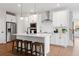 Island kitchen with white shaker cabinets, stainless steel appliances, and hardwood floors at 1028 Rose Dr, Marietta, GA 30060