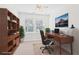 Virtually staged home office with built-in shelving at 2614 Grapevine Cir, Cumming, GA 30041