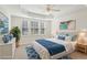 Virtually staged main bedroom with coastal decor and large windows at 2614 Grapevine Cir, Cumming, GA 30041