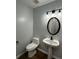 Updated half bathroom with pedestal sink and modern vanity lighting at 268 Springbottom Dr, Lawrenceville, GA 30046