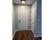 The entryway features a white door, a light fixture, and wood-look floors at 268 Springbottom Dr, Lawrenceville, GA 30046