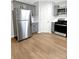 Well-lit kitchen featuring stainless steel appliances and gray cabinets at 268 Springbottom Dr, Lawrenceville, GA 30046