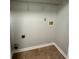 Well-lit laundry room with tile floor and ample shelving at 268 Springbottom Dr, Lawrenceville, GA 30046