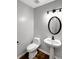 Powder room with pedestal sink, sleek fixtures, and ample lighting at 268 Springbottom Dr, Lawrenceville, GA 30046