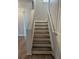 A staircase with wooden steps and white risers and stringers at 268 Springbottom Dr, Lawrenceville, GA 30046