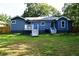 View of the back of the house and backyard, showcasing a spacious yard and patio at 3002 Laguna Dr, Decatur, GA 30032