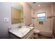 Bathroom featuring a single vanity with a white countertop and tile flooring and a tub/shower combo with tile surround at 3002 Laguna Dr, Decatur, GA 30032