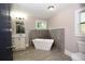 Contemporary bathroom with a freestanding tub, wood look tile floor, and modern fixtures at 3002 Laguna Dr, Decatur, GA 30032